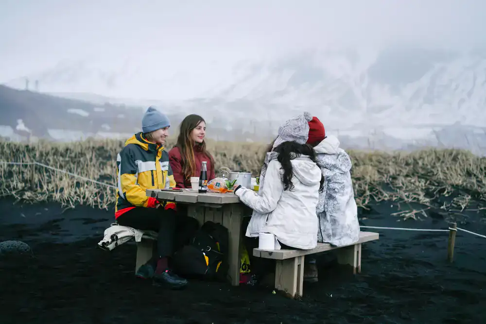 Group of friends smiling in warm hats after a cold swim
