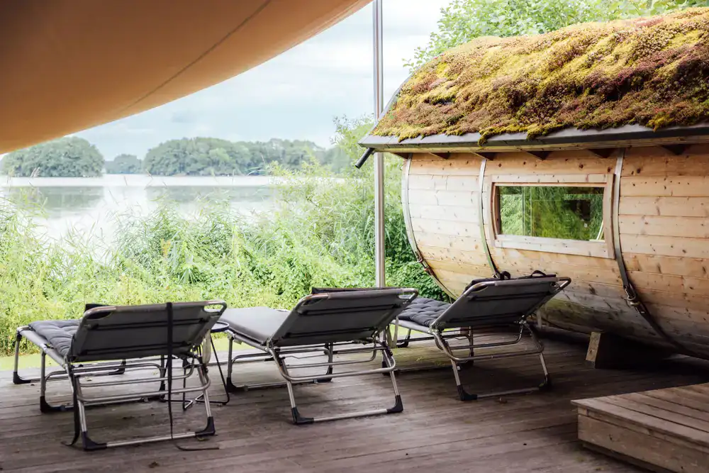 Wooden sauna building near a natural body of water